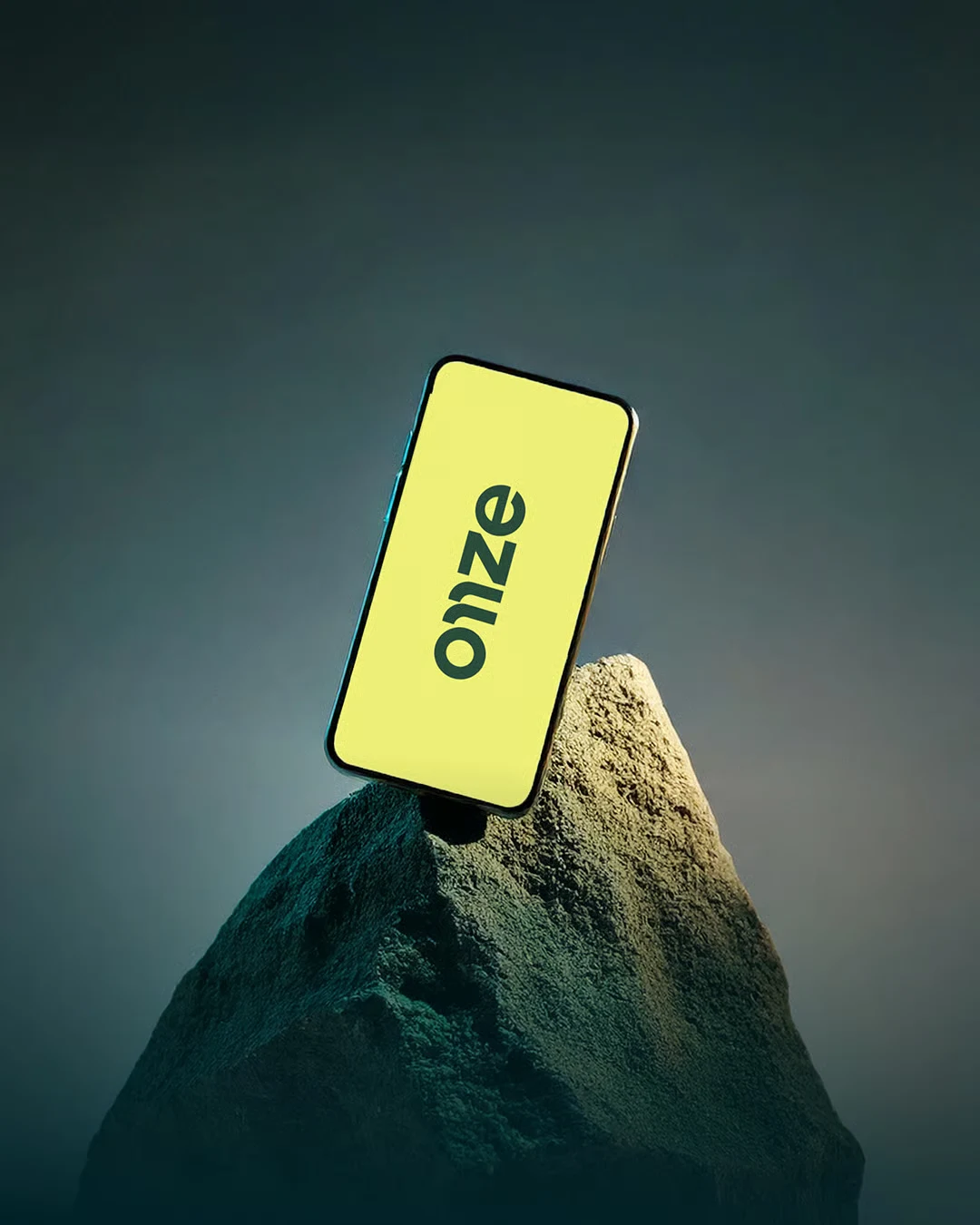 Onze’s yellow wordmark on a phone resting on a rock